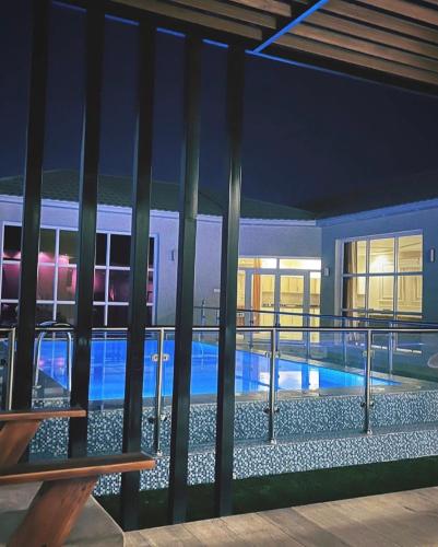 vista para uma piscina a partir de um edifício à noite em شاليه هابي نايت em Al Harazat
