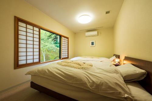 Giường trong phòng chung tại Auberge Funoki