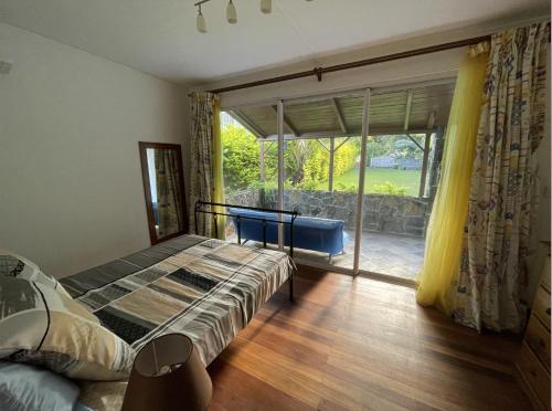 a bedroom with a bed and a large window at Ground Floor Apartment -Villa Ibiza in Trou dʼ Eau Douce