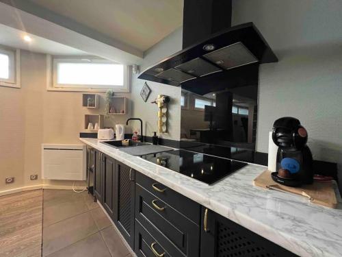 a kitchen with a black counter top and a sink at Relaxed appartment in Melun