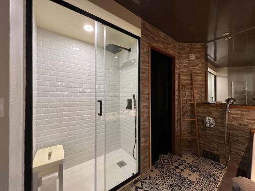 a bathroom with a shower with a glass door at Relaxed appartment in Melun