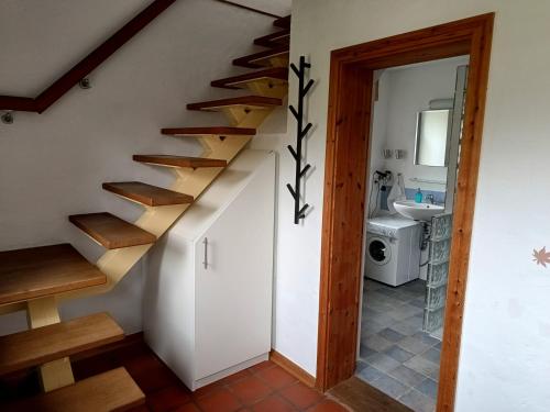 a staircase in a house with a bathroom at Ferienwohnung in Peetzig am See in Angermünde