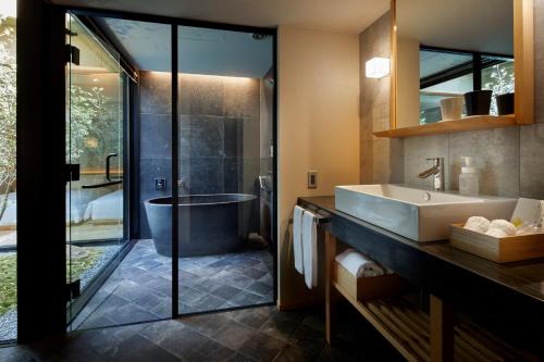 a bathroom with a tub and a sink and a shower at Agora Kyoto Karasuma in Kyoto