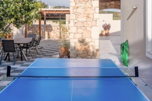 a blue ping pong table on a patio at Kiki's Seaview Villa in Gerani