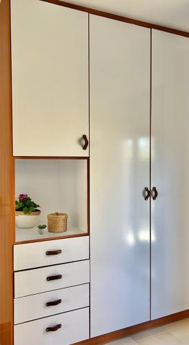 a white closet with white drawers and a white cabinet at Kiki's Seaview Villa in Gerani