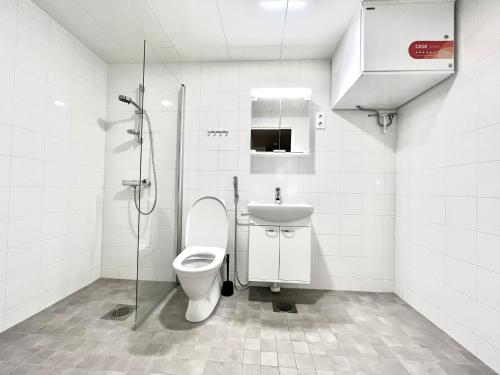 a bathroom with a toilet and a sink and a shower at Easy Stay Room near Airport in Vantaa