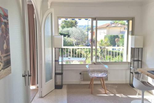 a room with a glass chair and a window at La Suite de Saint-Jean-Cap-Ferrat, vue mer et accès mer in Saint-Jean-Cap-Ferrat
