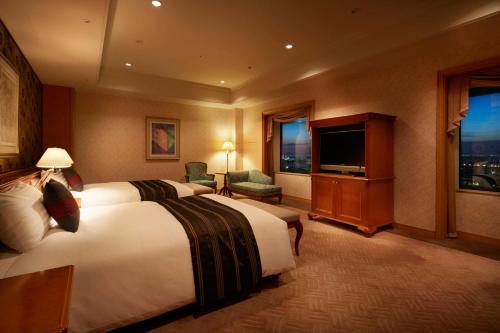 a hotel room with a bed and a flat screen tv at Hotel Agora Regency Osaka Sakai in Sakai