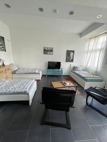 a living room with three couches and a table at Viersen Schöne Apartments am Dülkener Bahnhof Vi01 bis Vi09 in Viersen