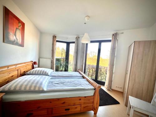 a bedroom with a bed and a large window at Alte Salzstraße 14 in Pogeez