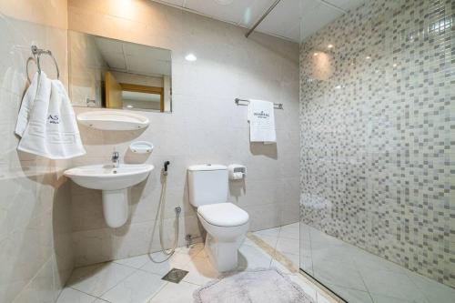 a bathroom with a toilet and a sink at Cozy spacious Luxury Studio in Dubai