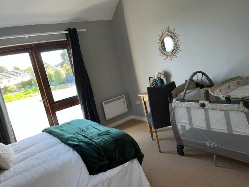 a bedroom with a bed and a table and a mirror at Villa in Youghal - Carleton Village in Youghal
