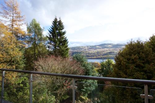 a view of a lake from a balcony at LOCH TAY HIGHLAND LODGES and GLAMPING PARK in Morenish