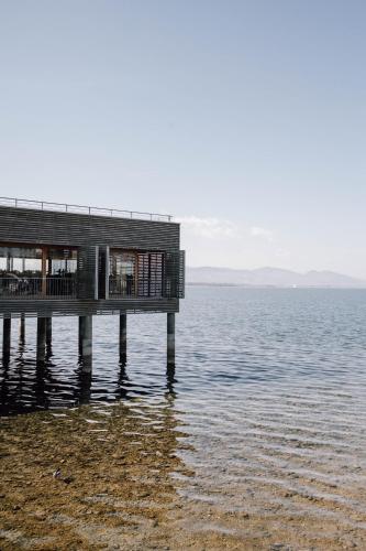 a house on a pier on the water at Seehotel am Kaiserstrand in Lochau