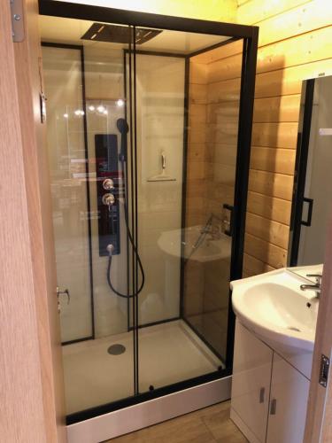 a glass shower in a bathroom with a sink at Chalet Jad'Orres in Les Orres