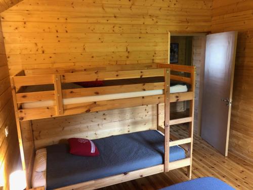 a bedroom with two bunk beds in a log cabin at Chalet Jad'Orres in Les Orres