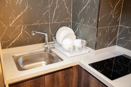 a kitchen counter with a sink and a plate at Gwanganli The Club Hotel in Busan