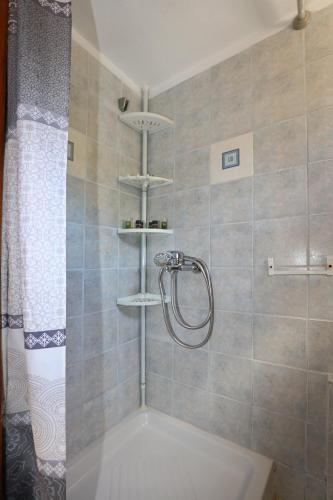 a bathroom with a shower with a shower curtain at Villa Pefkias in Skopelos Town