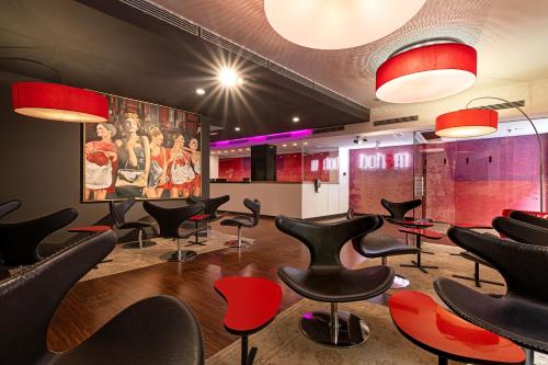 a waiting room with black chairs and red chairs at Bohem Art Hotel in Budapest