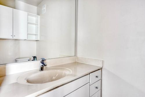 a white bathroom with a sink and a mirror at Somerville 1BR w WD nr Assembly T BOS-757 in Somerville