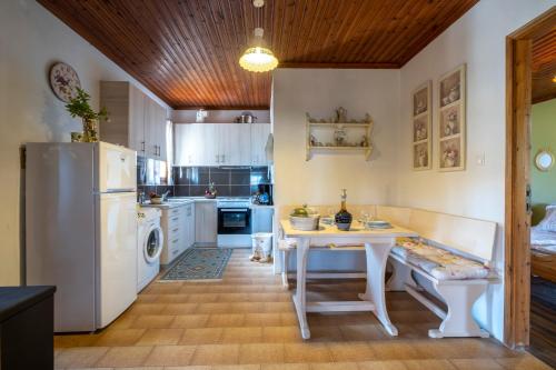 a kitchen with a white table and a refrigerator at Guest House Sklithro in Sklíthron