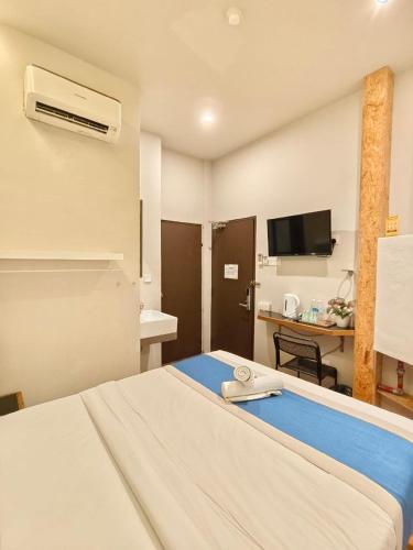 a hotel room with a bed and a desk at The Riverbank Hotel By MRVJ Business in Kuantan