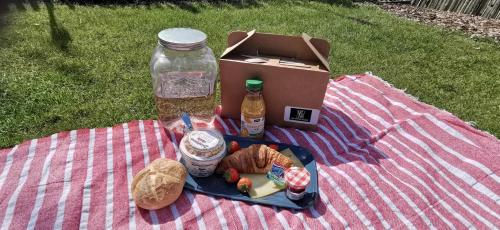 una mesa de picnic con una caja y un plato de comida en Appartement YCW 'Papillon', en Rijnsaterwoude