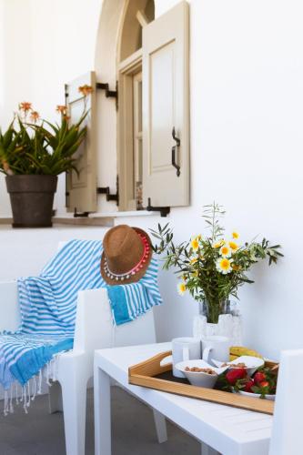 a white dining room with a white table and chairs at Villa Dina with private Juccuzi in Perissa