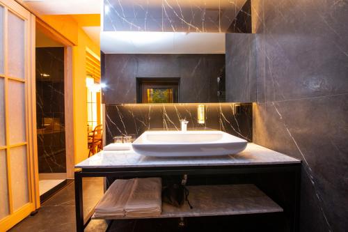 a bathroom with a white sink on a counter at Gwanganli The Club Hotel in Busan