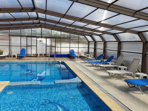 a large swimming pool with chairs and a swimming pool at White House in Ognyanovo