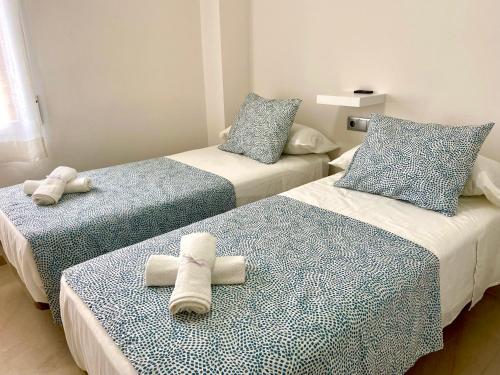 מיטה או מיטות בחדר ב-Apartamento San Gerardo By Solymar Holiday