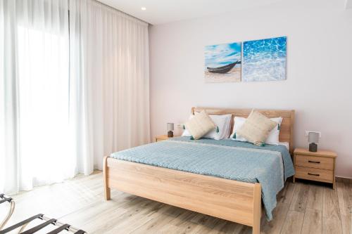 a bedroom with a bed with a blue bedspread at Beach Deluxe House in Kos Town