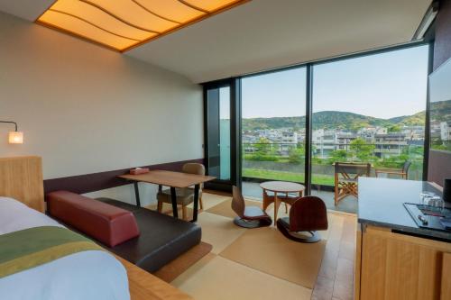 a hotel room with a view of the city at Genji Kyoto, a Member of Design Hotels in Kyoto