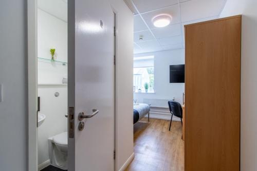 an open door to a room with a bedroom at For Students Only Ensuite Bedrooms at Danesgate House in Lincoln in Lincoln