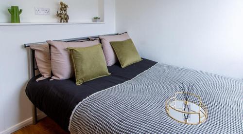 um quarto com uma cama com almofadas em For Students Only Ensuite Bedrooms at Danesgate House in Lincoln em Lincoln