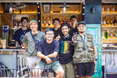 a group of men standing in front of a bar at Republic Hostel Cat Ba in Cat Ba