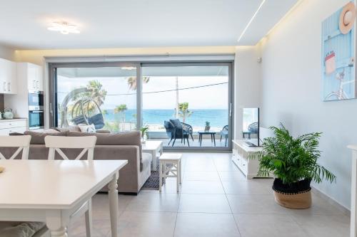 a living room with a view of the ocean at Beach Deluxe House in Kos Town
