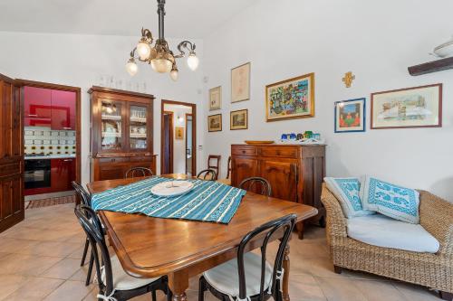 a dining room with a wooden table and chairs at Villa Viola in Torre delle Stelle