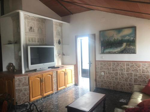 a living room with a flat screen tv on the wall at Villa Dona Mencia in Doña Mencía