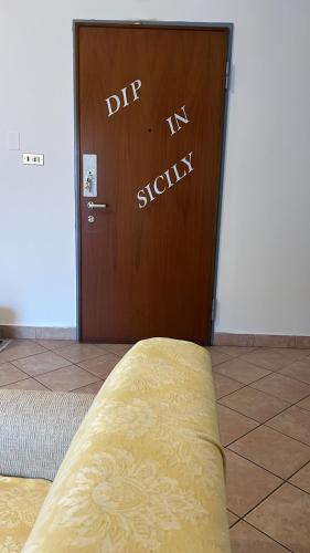 a door with the words dip new society written on it at DIP IN SICILY in Lentini