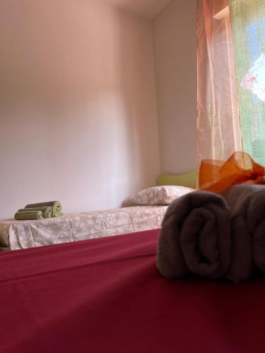a bedroom with two beds and a window at DIP IN SICILY in Lentini