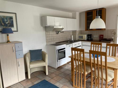 a kitchen with a table and chairs and a dining room at Landhaus Monika in Bodensdorf