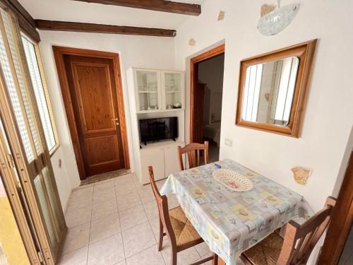 a small dining room with a table and chairs at Appartamento Nassia 2 By La Via Del Mare Viaggi e Vacanze in Villasimius