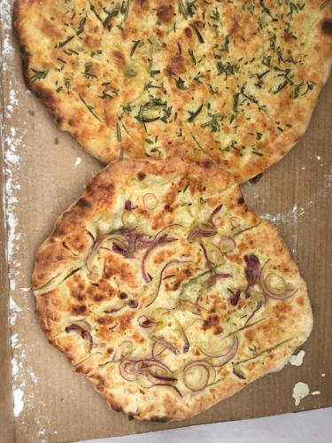 two slices of pizza sitting on top of a box at La Fratta Art - House in Marsciano