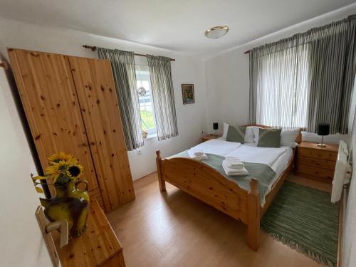 a bedroom with a large wooden bed in a room at Landhaus Monika in Bodensdorf
