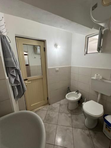 a bathroom with a toilet and a sink at Sea House in Vlorë
