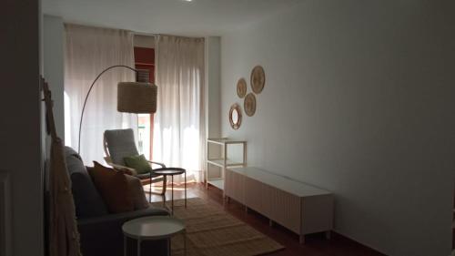 a living room with a couch and a chair at Apartamento Jacaranda in Murcia