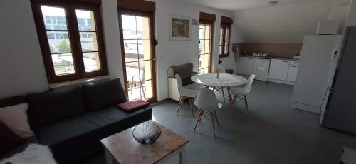 a living room with a couch and a table at Michlfarm Lounge in Korneuburg