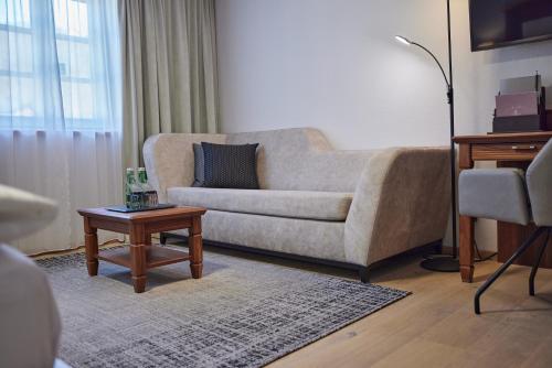 a living room with a couch and a coffee table at Hotel EDELWEISS Berchtesgaden Superior in Berchtesgaden