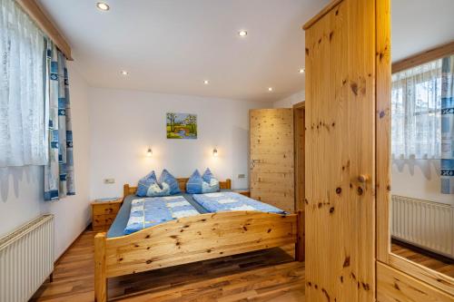 a bedroom with a large wooden bed in a room at Unterlehenhof A in Zell am Ziller
